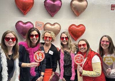 HR team members pictured with members from other departments celebrating Valentine's Day.