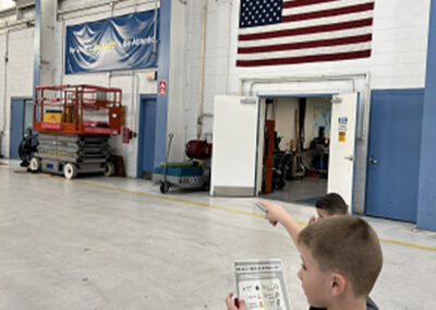 Kid that participated in Bring Your Kid To Work Day in Airshare hangar.