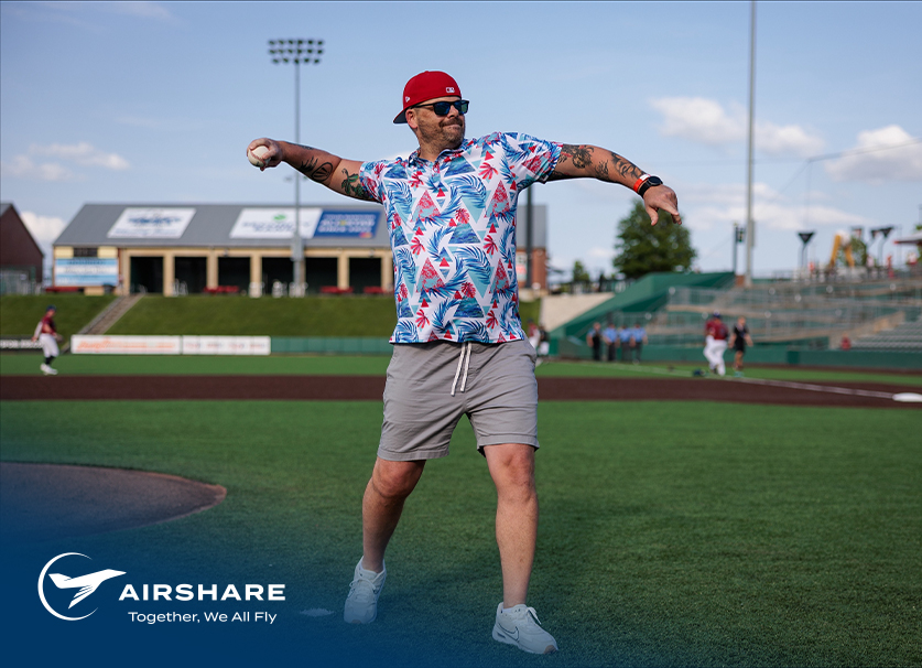 Hero-Img-Summer-Event-2025 Airshare Employee, TJ Miller, in position throwing the first pitch for Kansas City Monarchs baseball game.