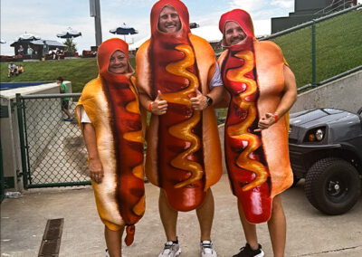 Airshare employees, Dawn Smith, Blake Mitton, and Taylor Kelly, dressed up as hot dogs for the Hot Dog Race.