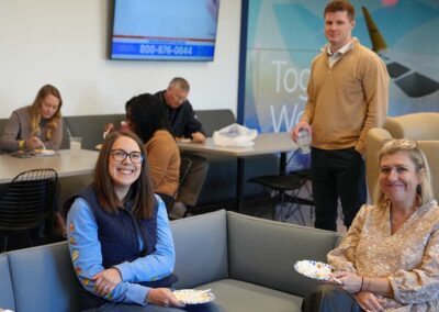 Airshare employees at CHQ conversing and gathered for pie contest.