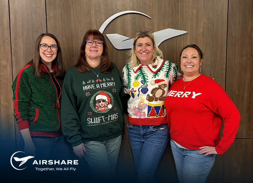 Airshare employees, Kelsey P., Vaughn H., Brittany B., Nicole K., pictured together in their festive green and red holiday sweaters.