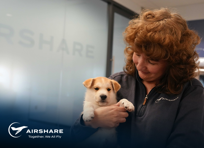 Arishare employee, Lyna, holding a puppy.