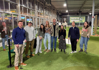 Airshare's CHQ employees gathered playing putt-putt together celebrating the holiday party.