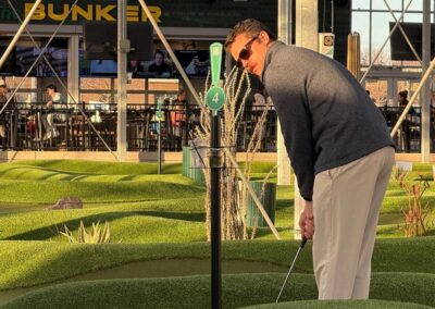 Airshare employee playing putt-putt celebrating the holiday party.