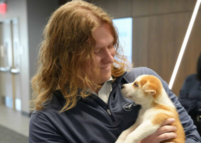 Airshare employee holding puppy,