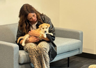 Airshare employee holding puppy,